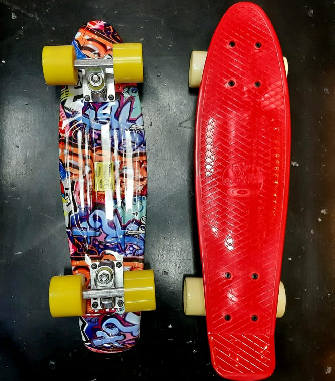 Two skateboards, one with graffiti art and yellow wheels, the other red with cream wheels.