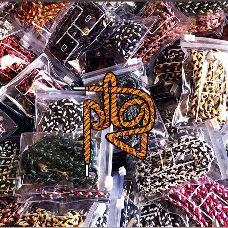 A pile of colorful, braided shoelaces packaged in clear plastic bags.