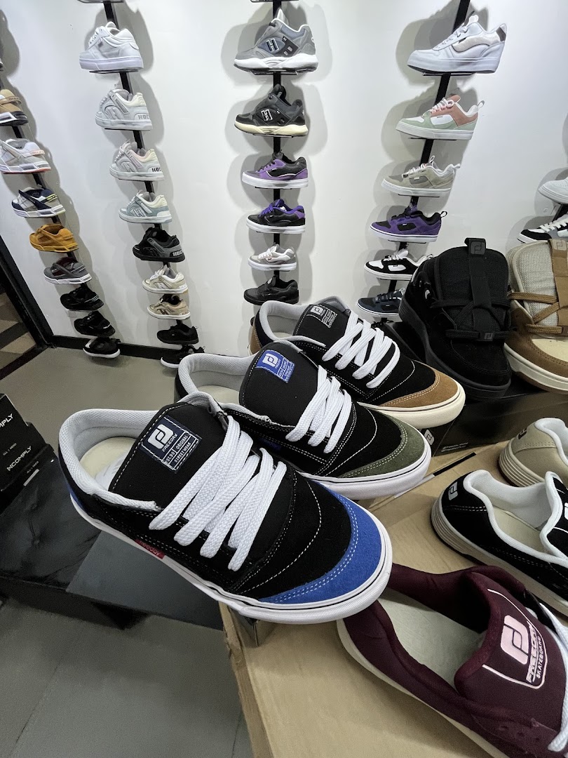 A display of various skate shoes in different styles and colors on shelves.