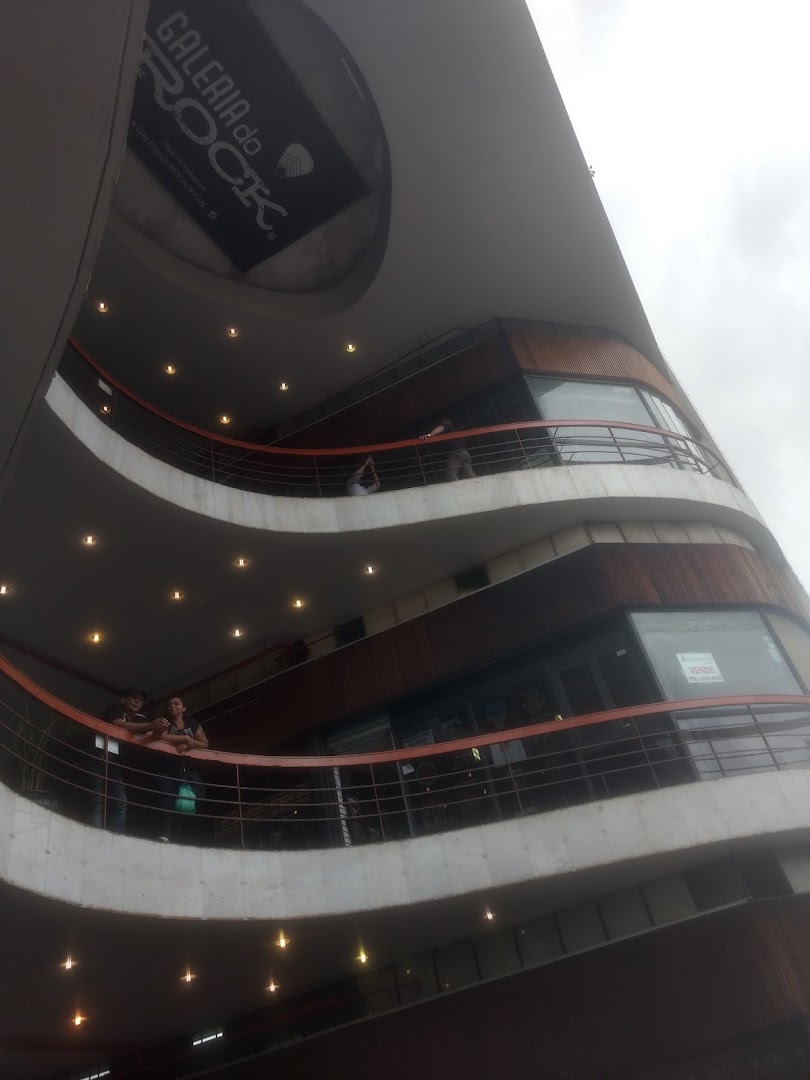 Exterior view of a multi-level building with balconies and shops, featuring a "Galeria do Rock" sign.