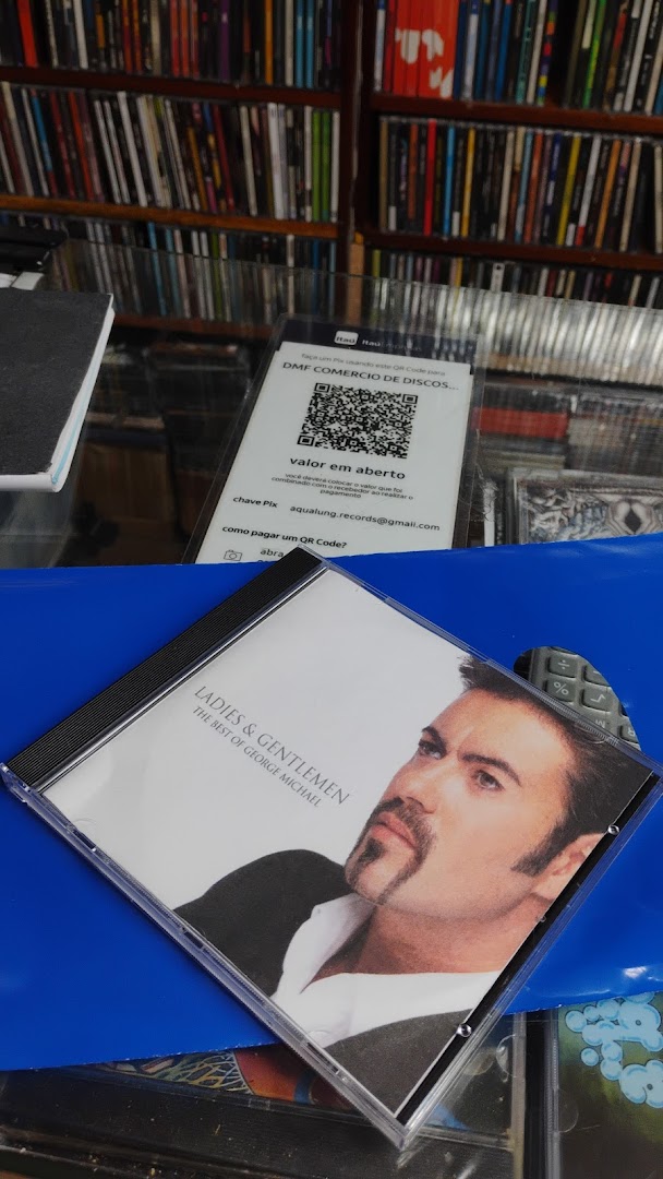 A CD of George Michael's 'Ladies & Gentlemen' is displayed in front of shelves filled with CDs.