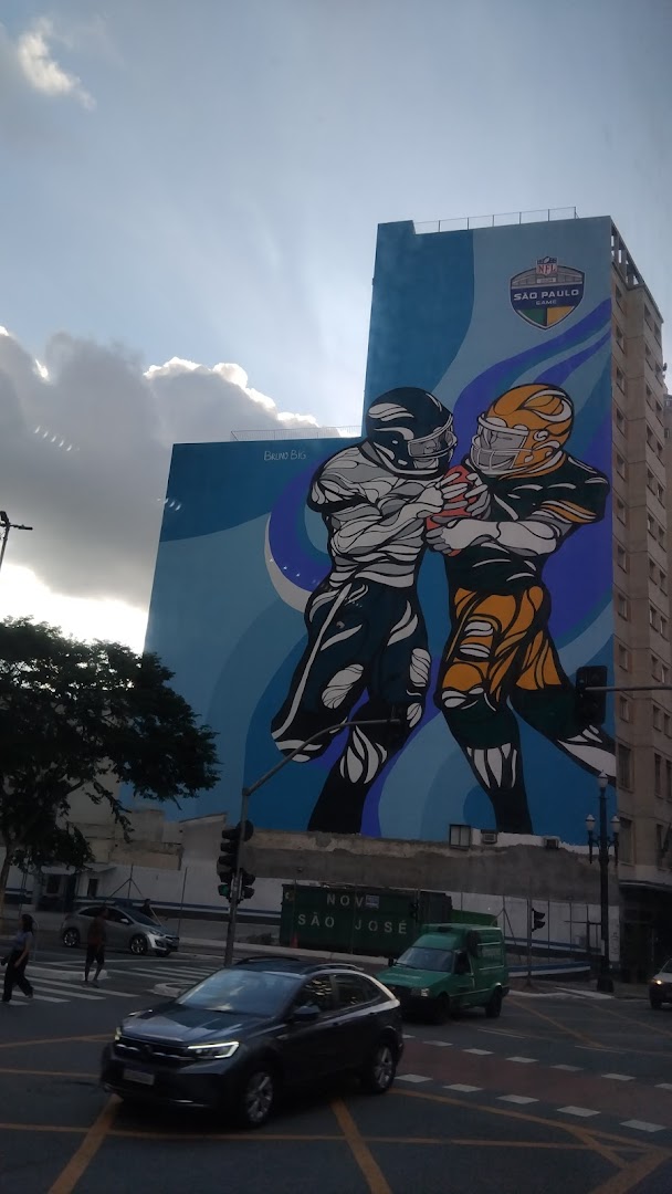 A large mural of two American football players on a building facade.