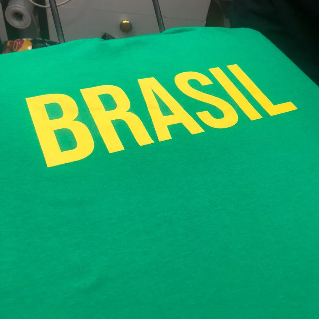 A green t-shirt with the word "BRASIL" printed in large yellow letters.