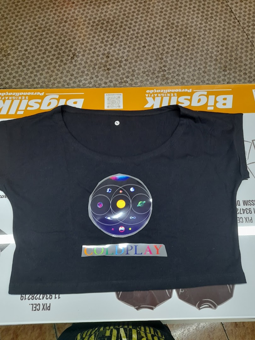 A black t-shirt with a Coldplay logo and a circular graphic.