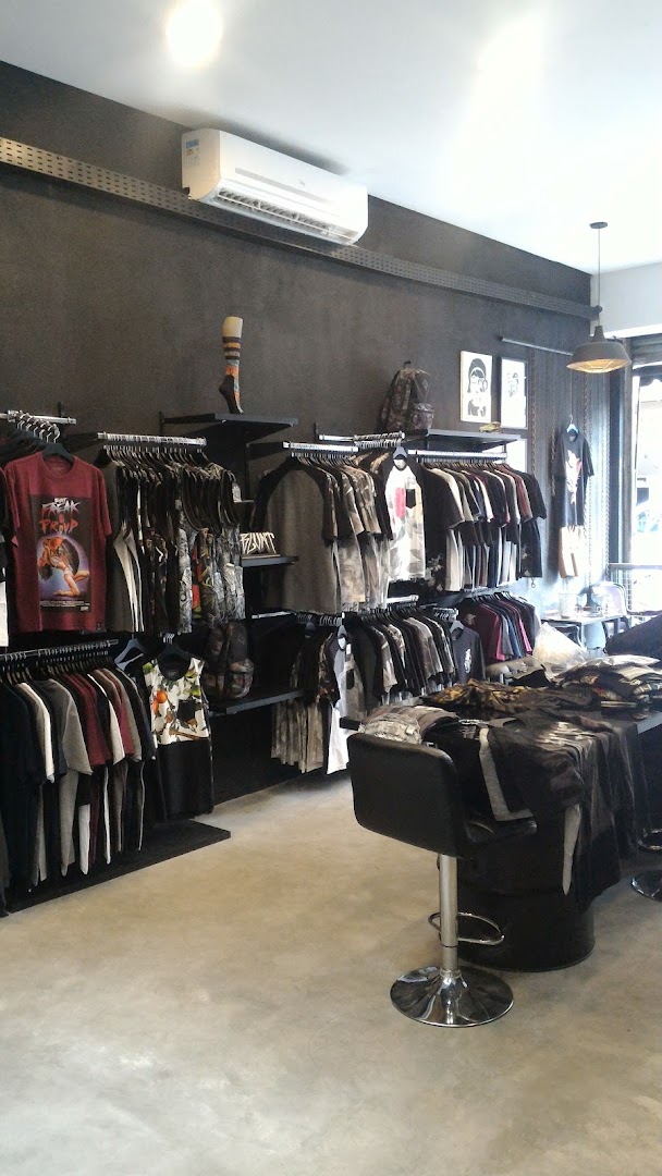 Interior view of a clothing store with racks of t-shirts and apparel.