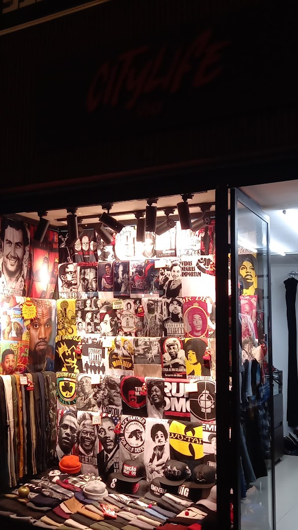CityLife Store window display featuring t-shirts and hats with iconic figures and graphics.