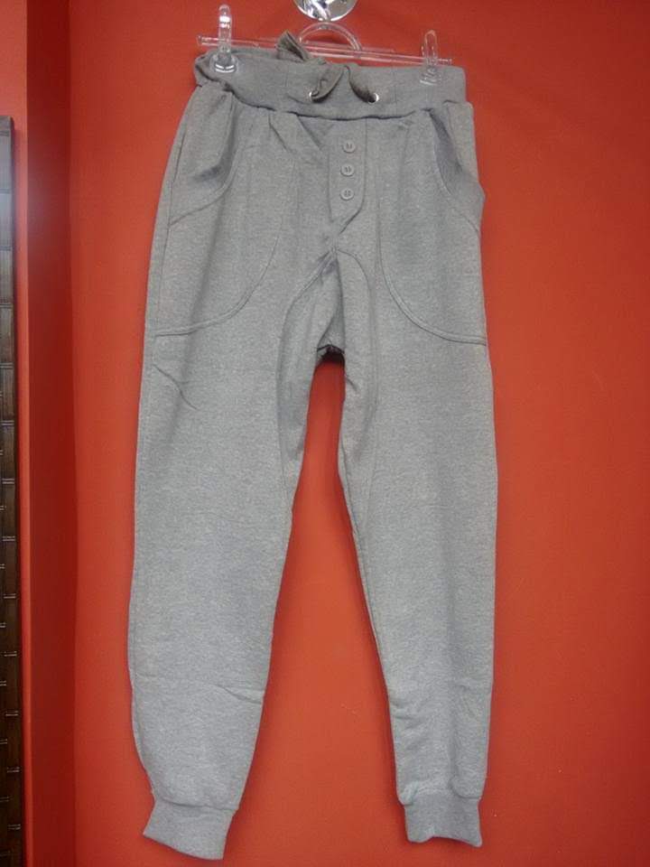 A pair of grey sweatpants with a drawstring waist and button detailing.