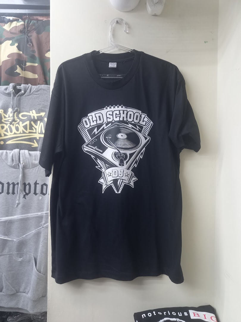 A black t-shirt with an 'Old School DJ' graphic hangs on a hanger, with other apparel visible.