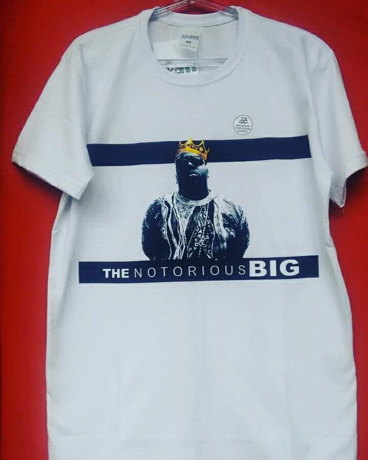 A white t-shirt featuring a graphic of The Notorious B.I.G. with a crown.