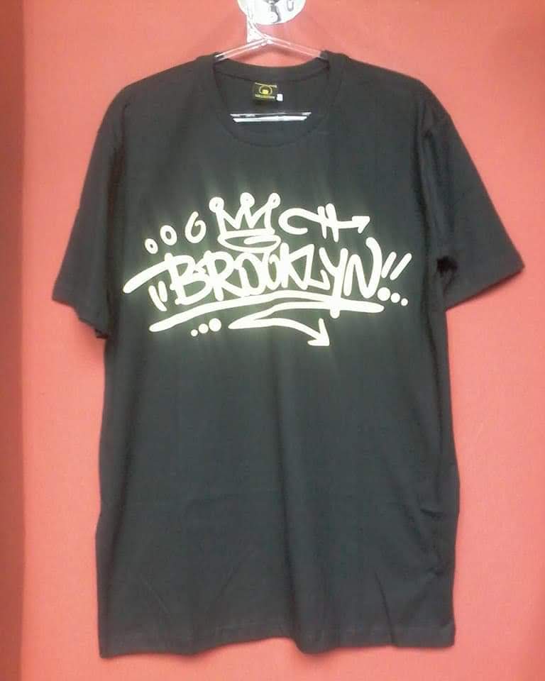A black t-shirt with white graffiti-style text that says "BROOKLYN!!" and a crown.