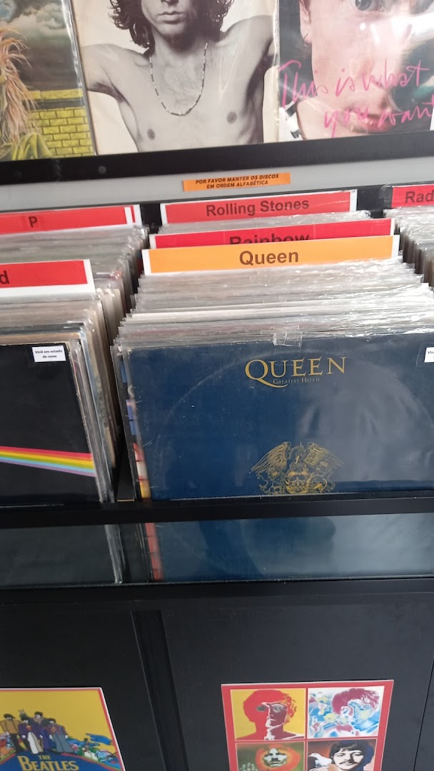 A display of vinyl records, featuring artists like Queen and The Beatles.