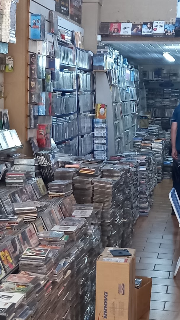 Interior of a shop filled with stacks of CDs and DVDs, showcasing a vast collection.