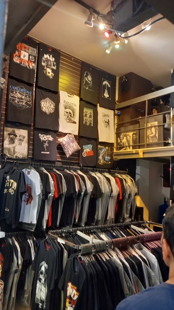 A shop interior displaying a wide selection of band t-shirts and apparel.