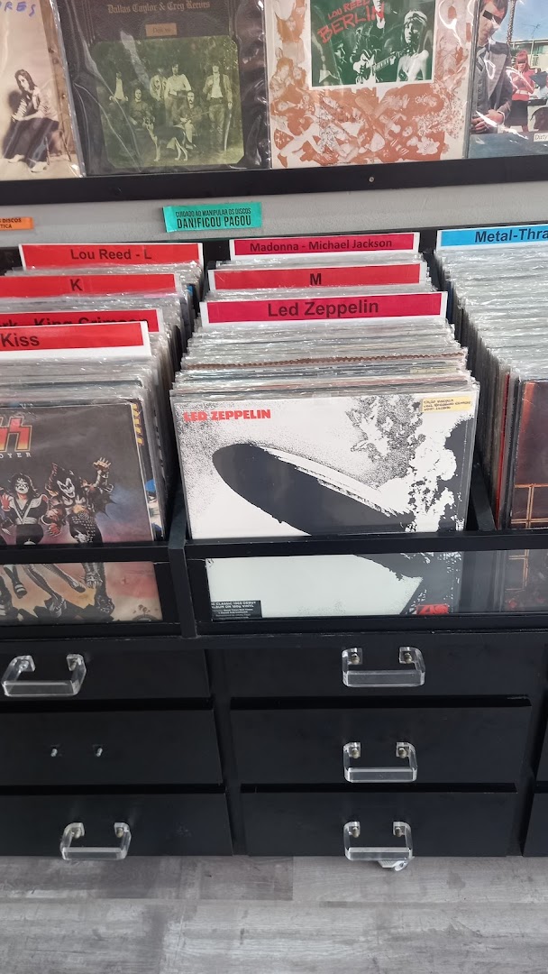 A display of vinyl records organized by artist, featuring classic albums.