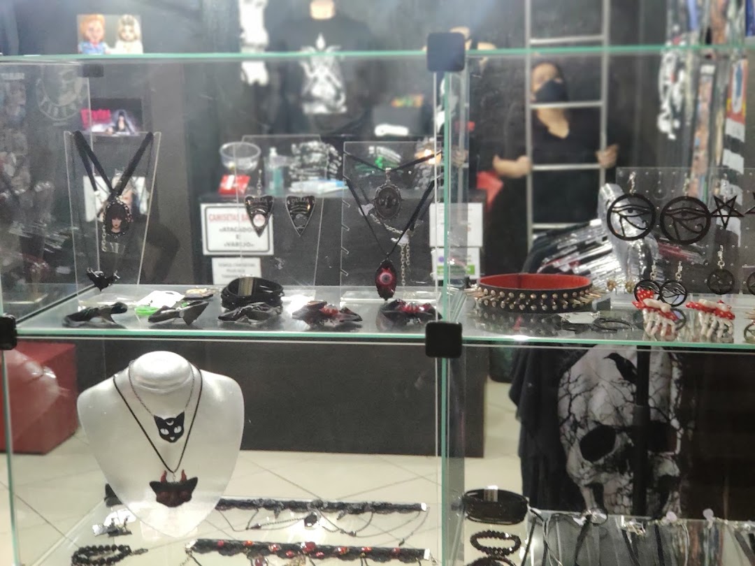 Display case filled with gothic jewelry and accessories, including necklaces, bracelets, and chokers.