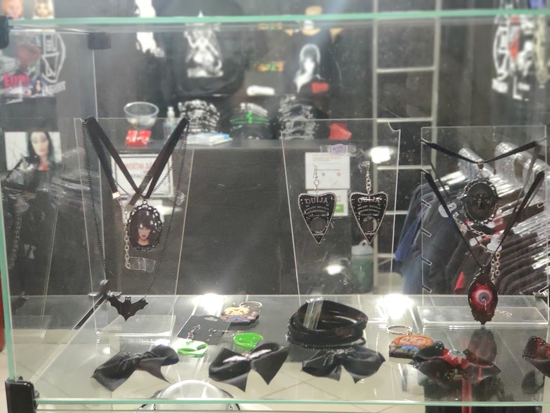 A display case filled with gothic-themed jewelry and accessories, including necklaces, earrings, and hair clips.