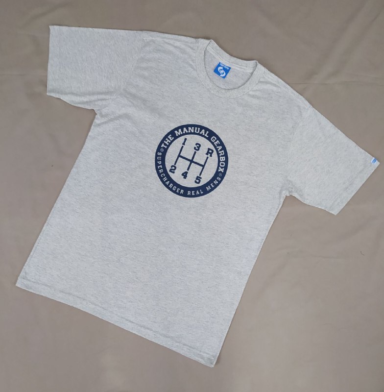 A light grey t-shirt with a dark blue graphic of a manual gearbox and text.