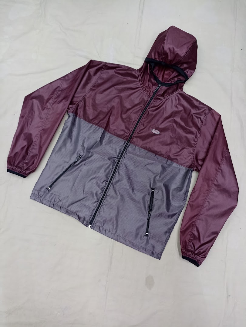 A maroon and grey hooded windbreaker jacket with a zipper closure and pockets.