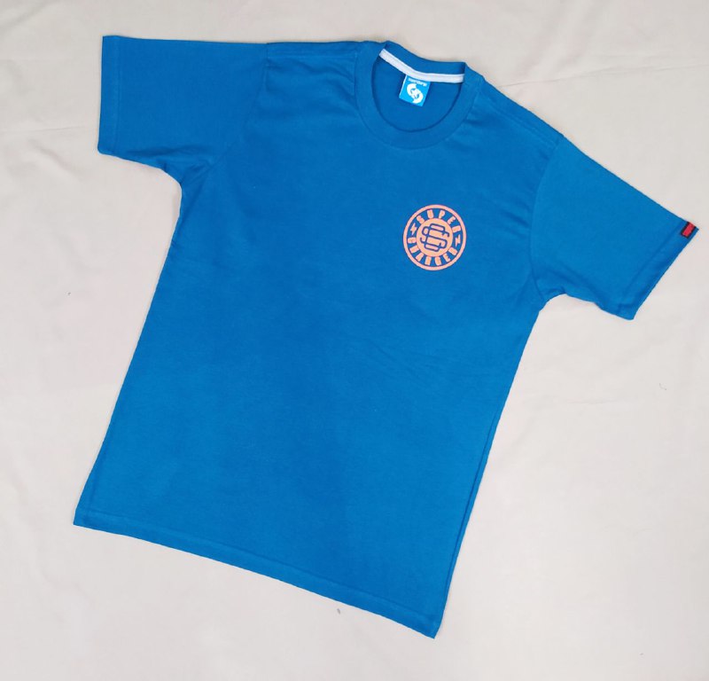 A bright blue t-shirt with a circular orange logo on the chest.