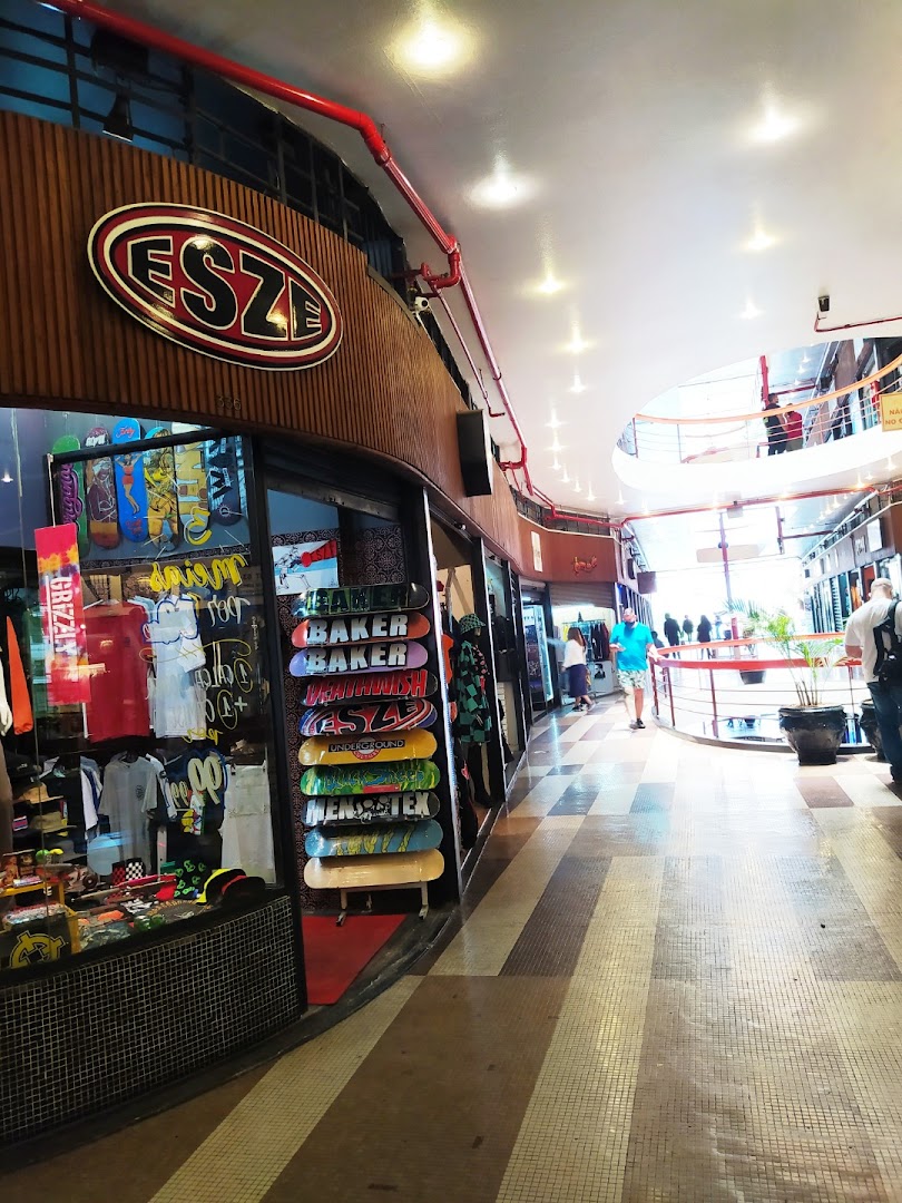 The Esze shop front displays skateboards and apparel, with a view of the mall's interior walkway.