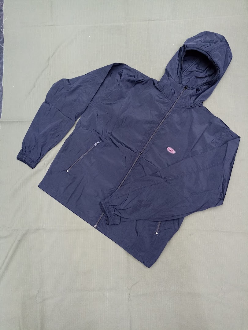 A dark blue hooded jacket with a zipper and pockets, laid flat on a textured background.