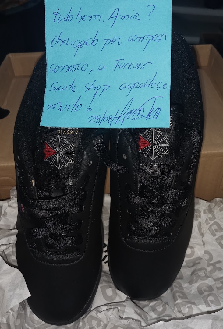 A pair of black skate shoes with a handwritten thank you note from Forever Skate Shop.