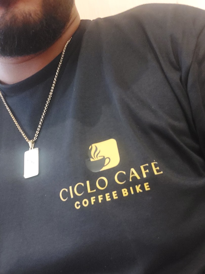 A person wearing a black t-shirt with the Ciclo Cafe Coffee Bike logo.