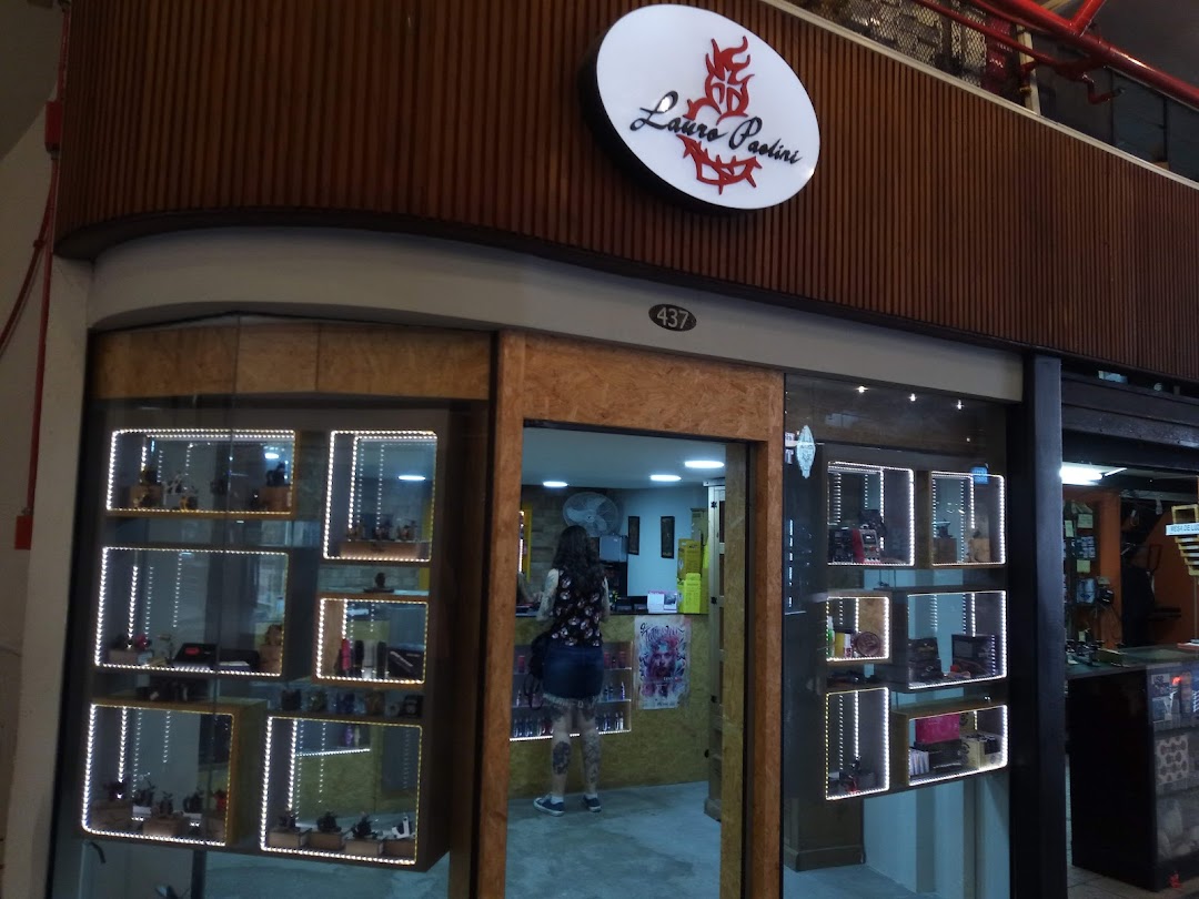 The Lauro Paolini shop front features illuminated display cases showcasing products and an open entrance.
