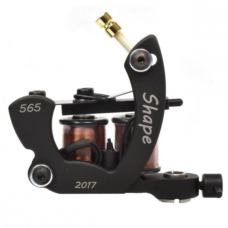 A close-up shot of a black tattoo machine with copper coils and gold accents.