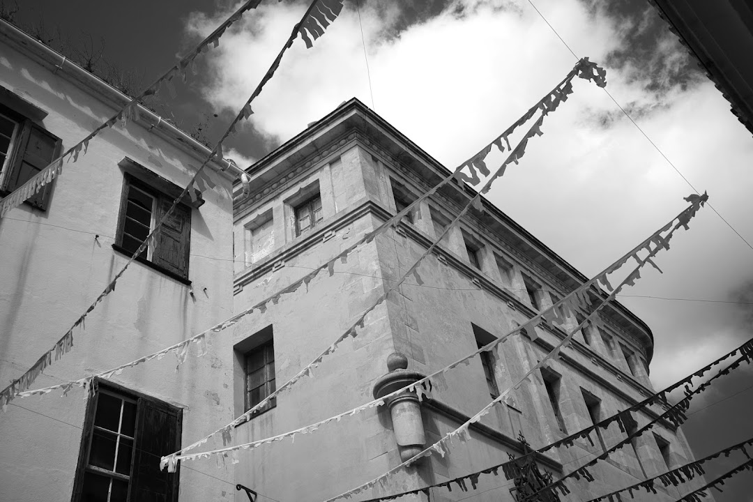 Black and white shot of buildings with festive banners strung across the sky.