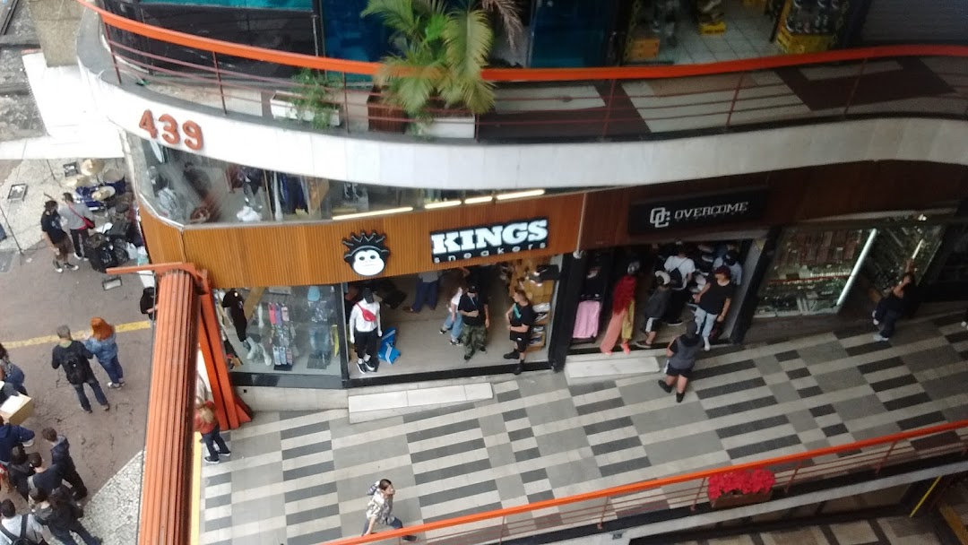 An aerial view of the Kings Sneakers shop entrance with people browsing inside.