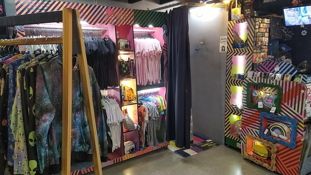 A retail shop interior displaying a variety of graphic t-shirts, hoodies, and accessories.