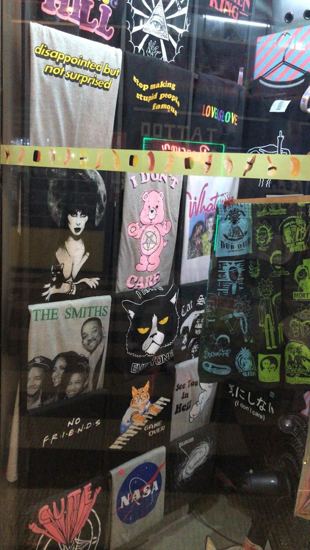 A display window showcasing various graphic t-shirts with pop culture and humorous designs.