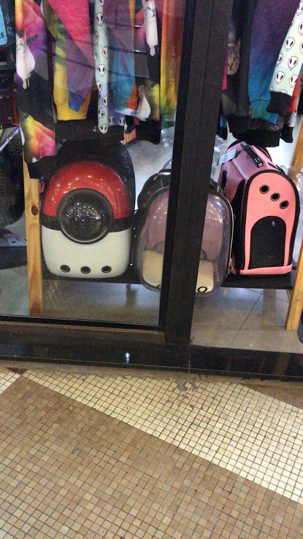 Shop window displaying colorful apparel and pet carriers, including a Pokemon-themed one.
