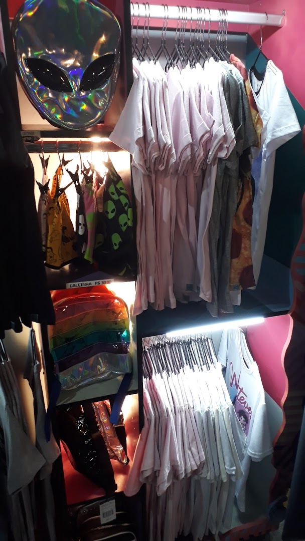 A retail display featuring t-shirts, bags, and accessories with unique designs.