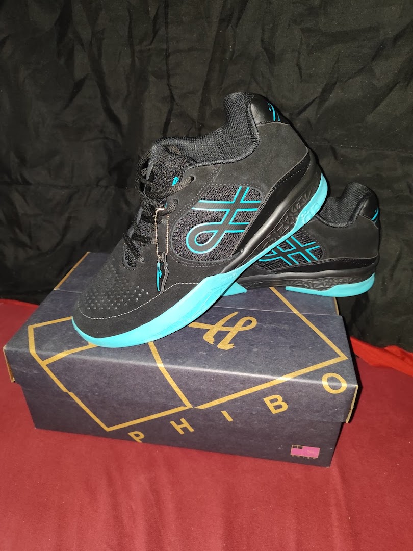 A pair of black and teal athletic shoes displayed on their matching box.