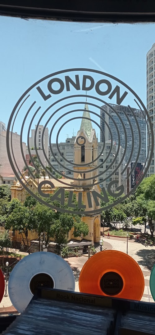 View through a window with a 'London Calling' logo, showing records and a cityscape with a church.