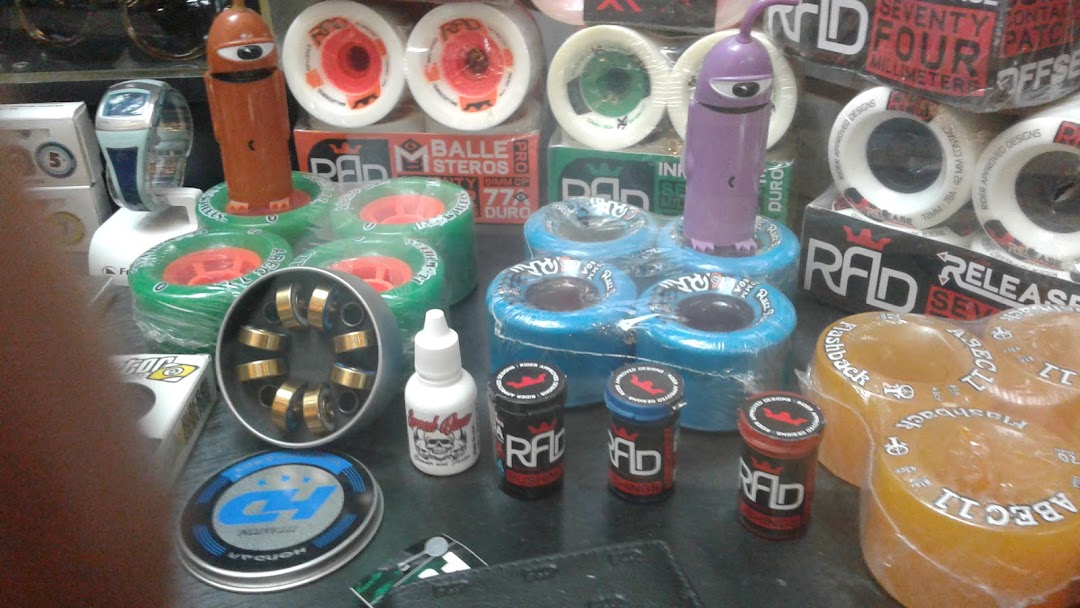 A collection of skateboard wheels, bearings, and accessories displayed on a shelf.