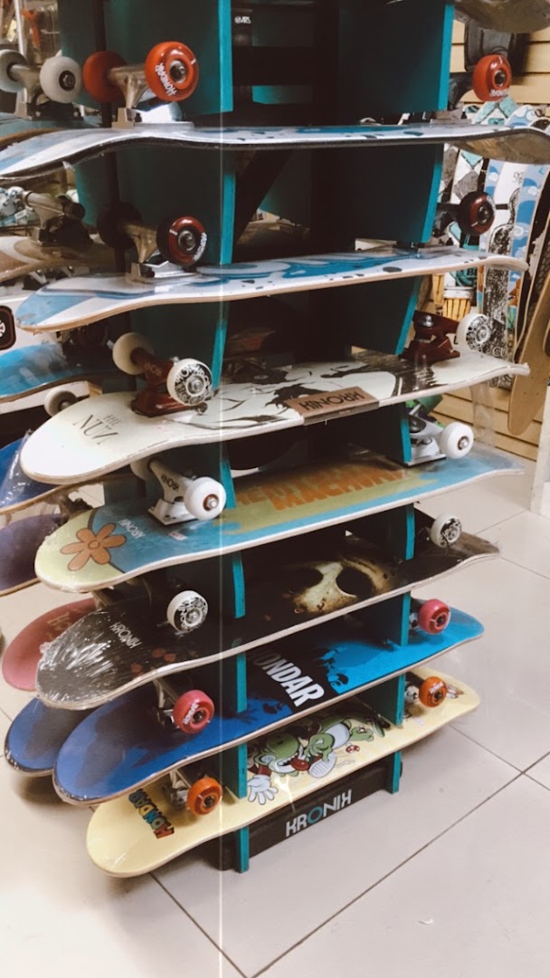 A multi-tiered display rack showcasing a variety of skateboards with colorful graphics and wheels.