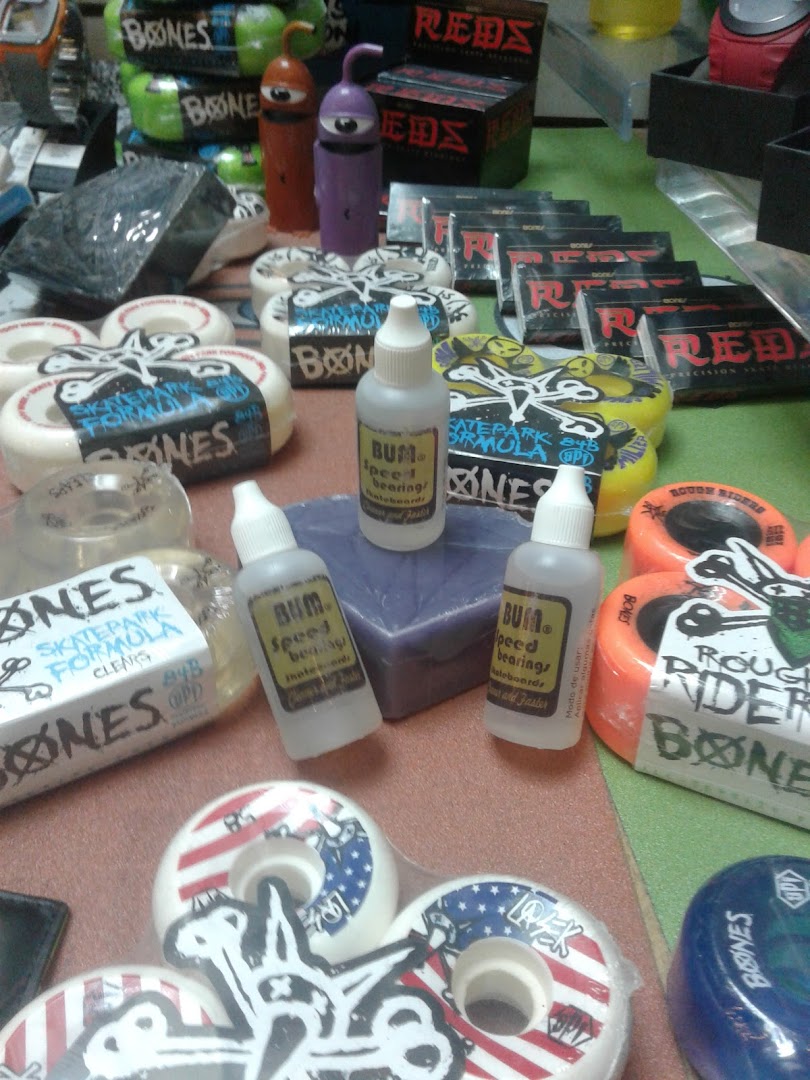 A collection of skateboard wheels and accessories, including bearings and small bottles of lubricant.