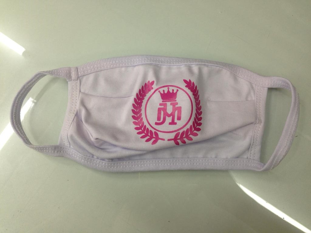 A white face mask with a pink logo featuring a crown and laurel wreath.