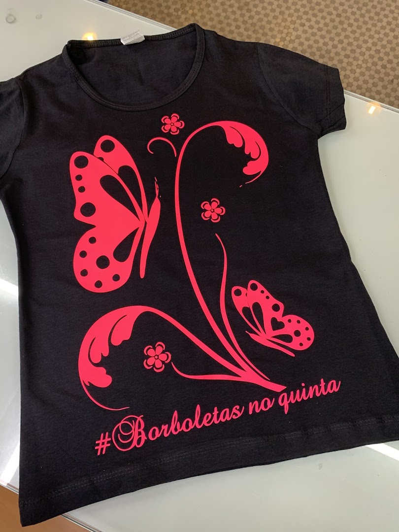 A black t-shirt with a vibrant pink butterfly and floral design.