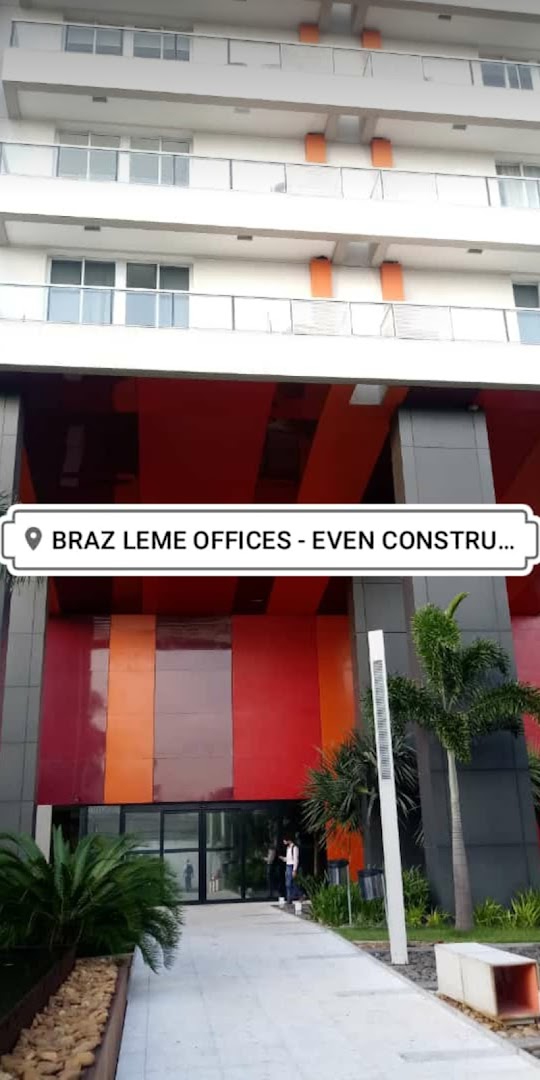 Modern office building entrance with colorful facade and glass doors.