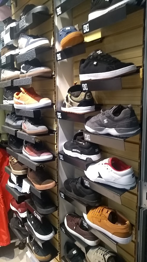 A wall display showcasing a variety of DC Shoes sneakers in different colors and styles.