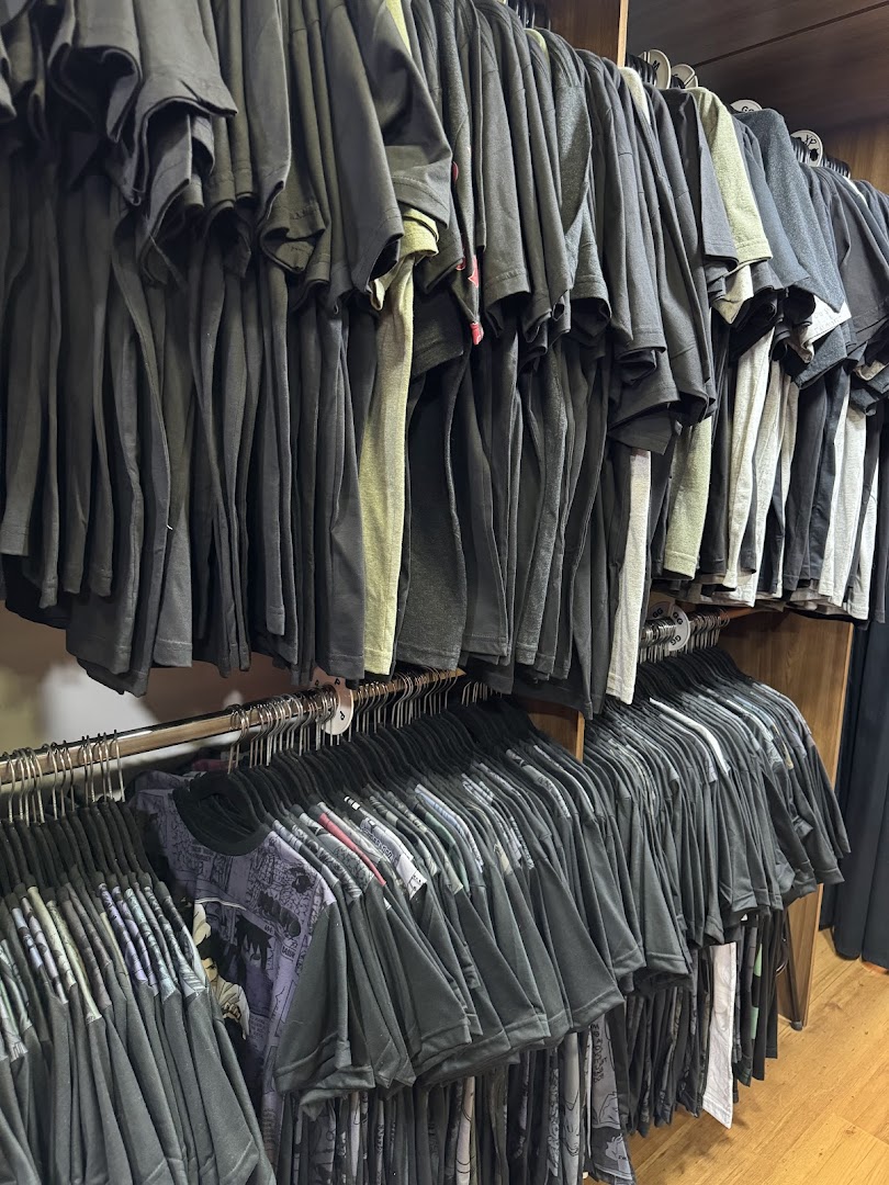 A wide selection of t-shirts displayed on racks, featuring various designs and colors.