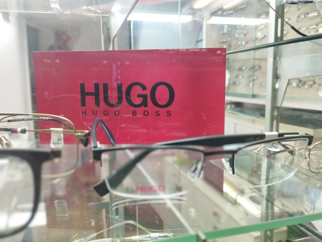 A display of eyeglasses with a Hugo Boss branded sign in the background.