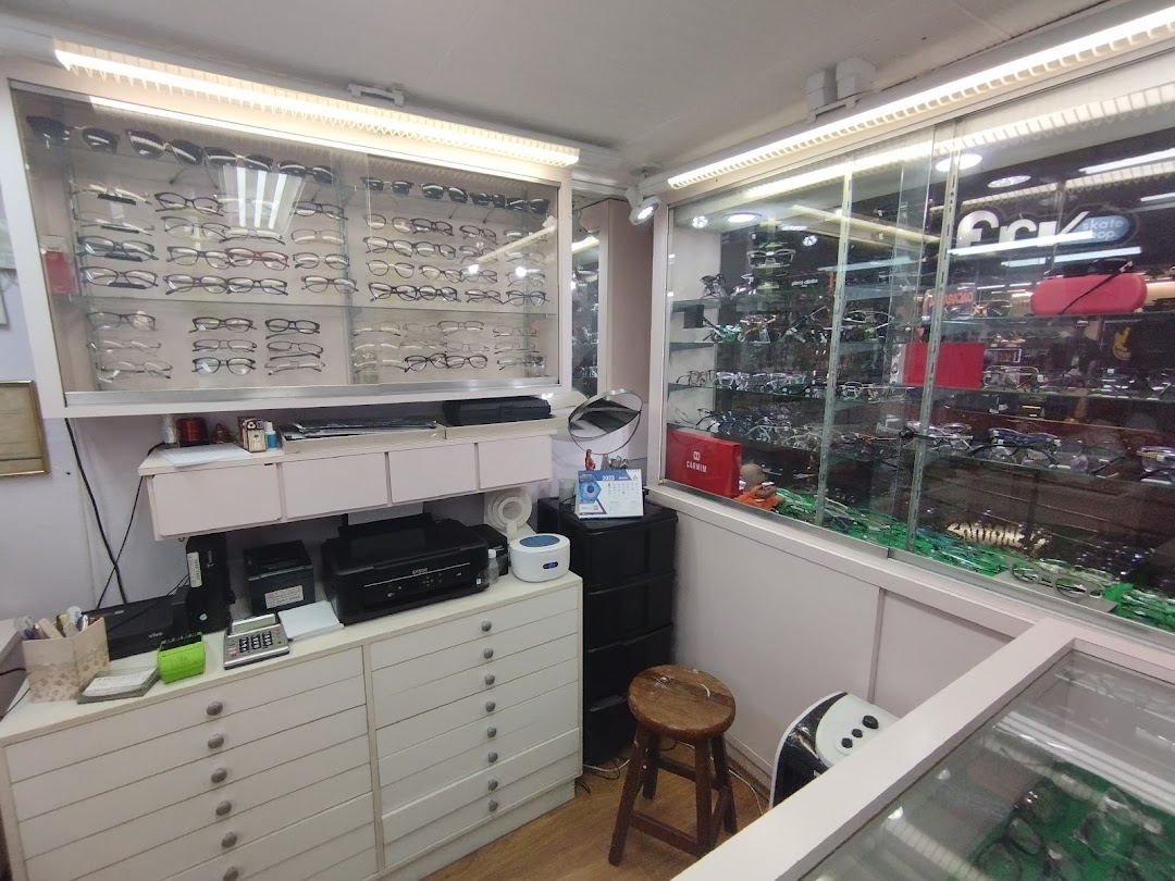 Interior of an optical shop showcasing a wide selection of eyeglasses and optical equipment.