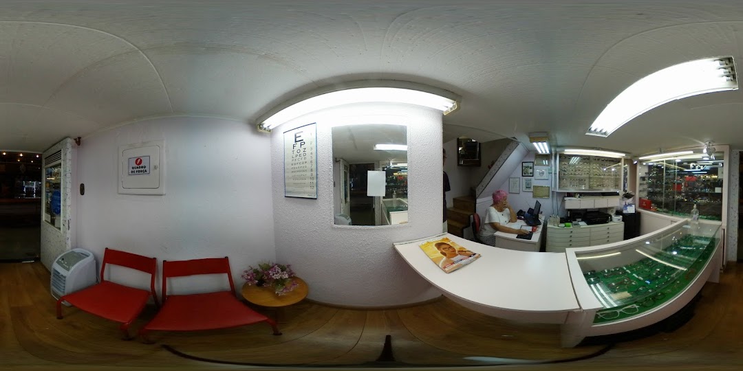 Interior view of an optical shop with a display of eyeglasses and a seating area.