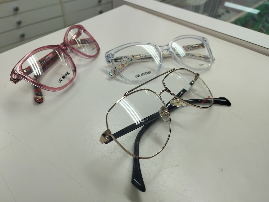 Three pairs of stylish eyeglasses are displayed on a white surface.