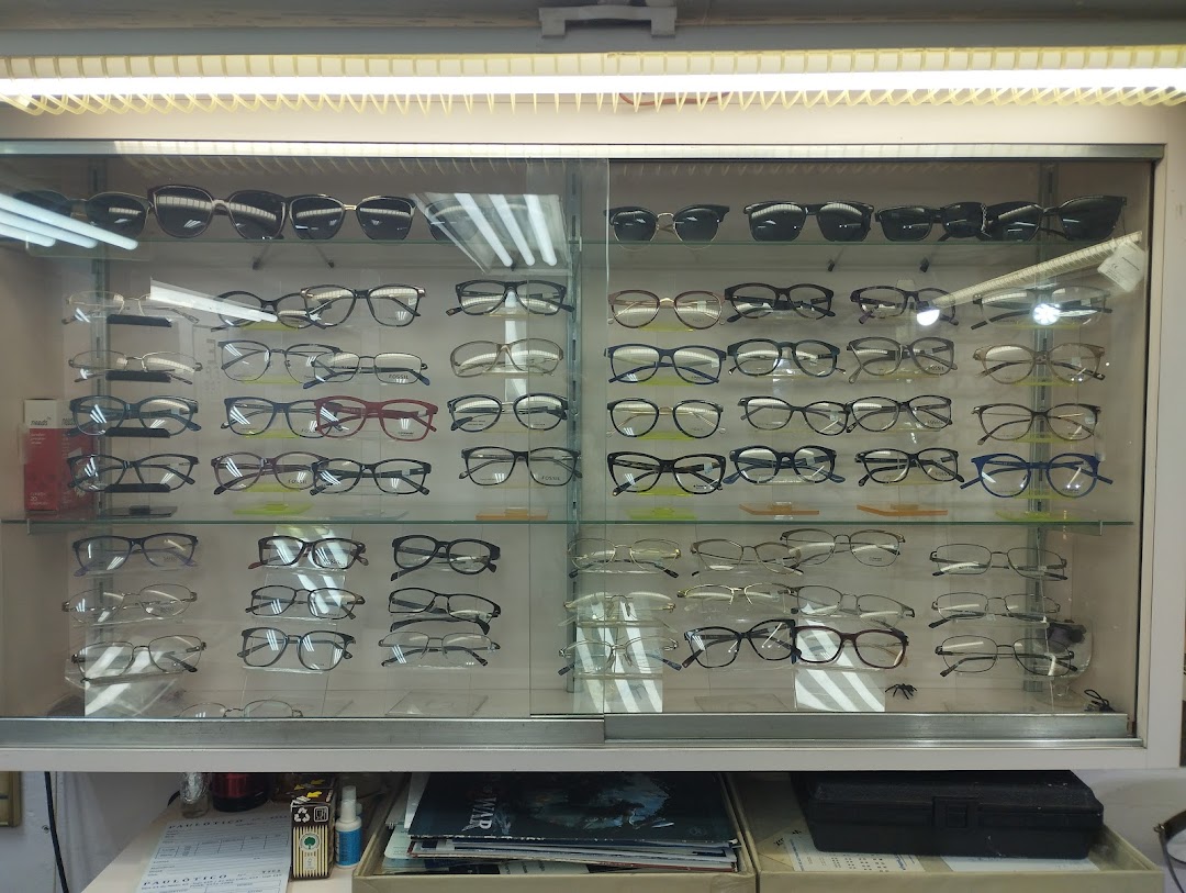 A display cabinet filled with various styles of eyeglasses and sunglasses.